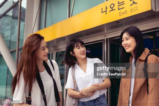 young korean tourists just arrived in the city - korean teen stock pictures, royalty-free photos & images