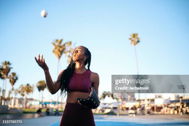 young woman practicing baseball near venice beach, california - playing catch stock pictures, royalty-free photos & images