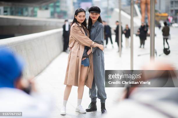 Guests wearing grey overall flat cap and trench coat, denim mini skirt seen at the Hera Seoul Fashion Week 2019 F/W at Dongdaemun Design Plaza at...