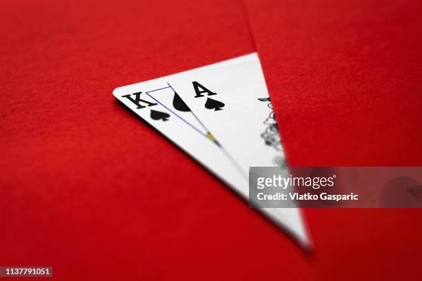 playing cards, king and ace on red surface - texas hold 'em stock pictures, royalty-free photos & images