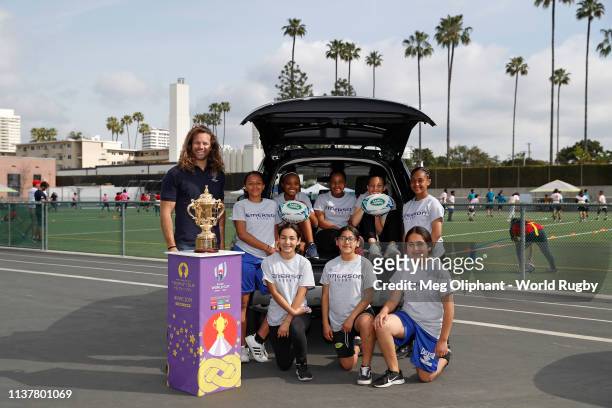 Former U.S.A. Eagles captain Todd Clever poses for a photo with Emerson Middle School students and The Webb Ellis Cup during Land Rover's official...