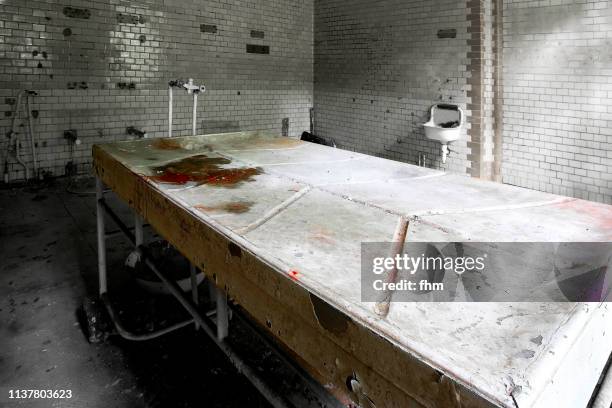 dissection table in an abandoned hospital - funeral parlor ストックフォトと画像