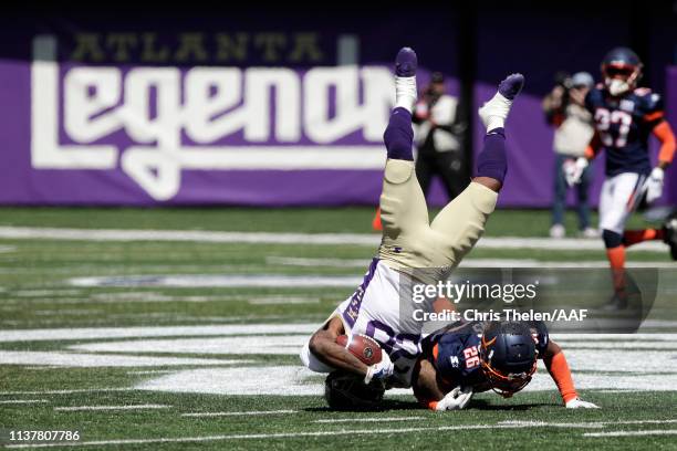 Tarean Folston of the Atlanta Legends is upended as he is tackled by Josh Evans of the Orlando Apollos during the first half in an Alliance of...