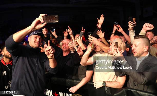 Heavyweight boxer Tyson Fury takes a selfie with fans at Morningside Arena on March 23, 2019 in Leicester, England.