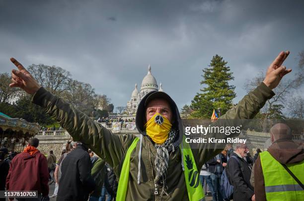 Gilets Jaunes or 'Yellow Vest' protestors chant against President Macron and his government in front of Sacre Coeur during Act 19 of protests on...
