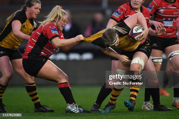 Gloucester hooker Kelsey Jones gets to grips with Wasps number 8 Liz Crake during the Tyrrells Premier 15s match between Gloucester Hartpury and...