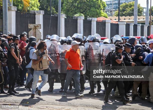 Riot police are deployed as opposition protesters demonstrate against the government at a parking lot in Managua on April 17, 2019. - Nicaragua's...