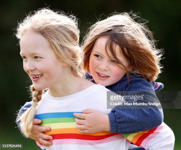 Savanah Phillips gives her cousin Mia Tindall a piggyback as they attend the Gatcombe Horse Trials at Gatcombe Park on March 23, 2019 in Stroud,...