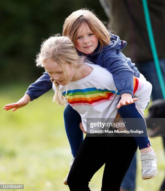 Savanah Phillips gives her cousin Mia Tindall a piggyback as they attend the Gatcombe Horse Trials at Gatcombe Park on March 23, 2019 in Stroud,...