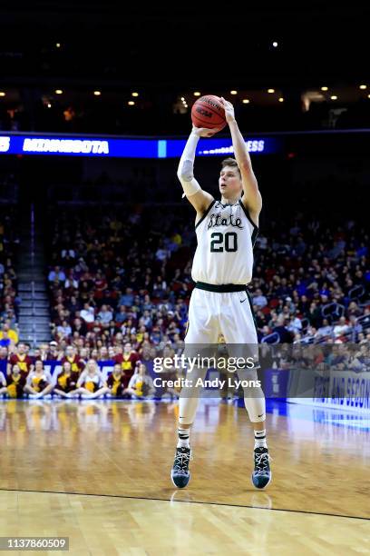 Matt McQuaid of the Michigan State Spartans shoots a three point basket against the Minnesota Golden Gophers during the second half in the second...