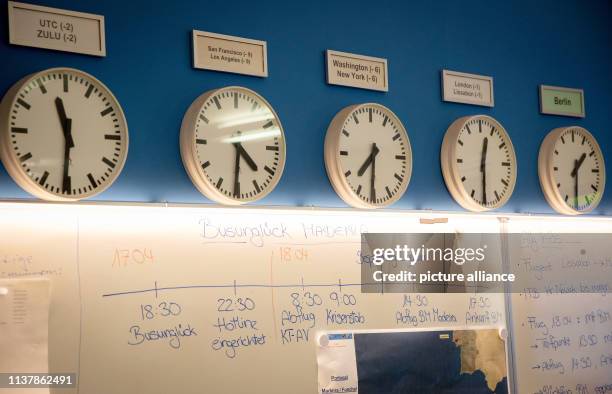 April 2019, Berlin: Clocks in the crisis staff of the Federal Foreign Office indicate the different time zones. Below is a timeline to the situation...