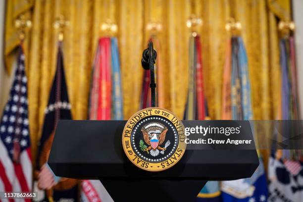 Podium with the presidential seal stands before the start of an event recognizing the Wounded Warrior Project Soldier Ride in the East Room of the...