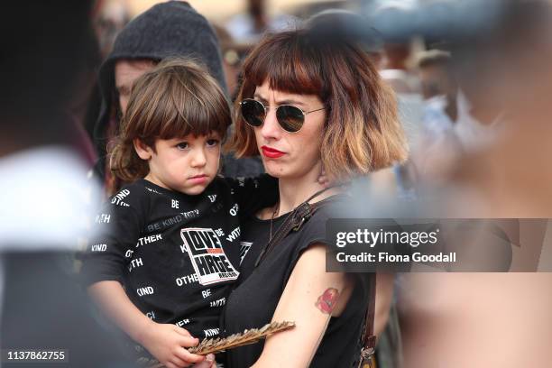 Woman carries her son during a march against racism at Aotea Square on March 24, 2019 in Auckland, New Zealand. 50 people were killed, and dozens...