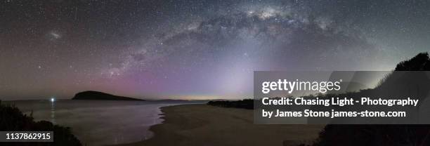 panorama of the milky way with a beam of zodiacal light underneath and a subtle aurora. - zodiacal light stock pictures, royalty-free photos & images