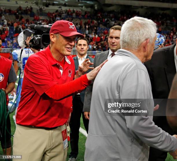 Mike Riley head coach of the San Antonio Commanders pats Dennis Erickson head coach of the Salt Lake Stallions at Alamodome on March 23, 2019 in San...