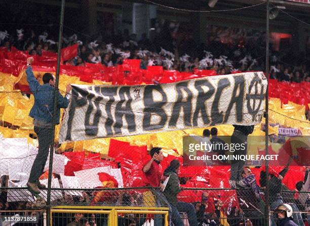 Real madrid ' soccer supporters fix an insulting banderole for Barcelona on a stadium fence during the soccer match of Spanish first division Real...