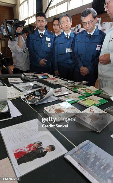 Tokyo Power Electric Co., President Masataka Shimizu is shown the family photographs and albums at an evacution center on May 4, 2011 in Nihonmatsu,...