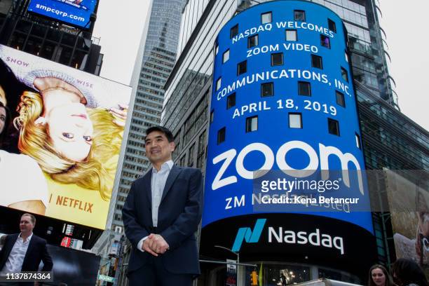 Zoom founder Eric Yuan poses in front of the Nasdaq building as the screen shows the logo of the video-conferencing software company Zoom after the...