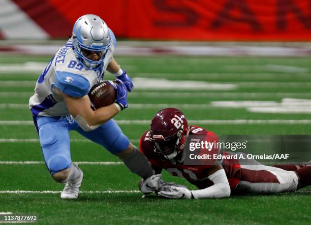 Tanner Balderree of the Salt Lake Stallions tries to shake the tackle of Duke Thomas of San Antonio Commanders at Alamodome on March 23, 2019 in San...