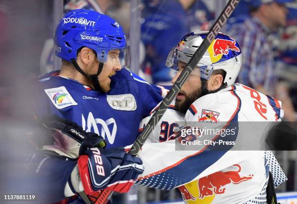 Brendan Mikkelson of the Adler Mannheim and Andreas Eder of EHC Red Bull Muenchen during the game between the Adler Mannheim and the EHC Red Bull...