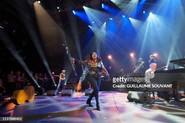 French singer Izia Higelin pays a tribute to her father, late singer Jacques Higelin, as she performs on stage during the 43rd edition of "Le...
