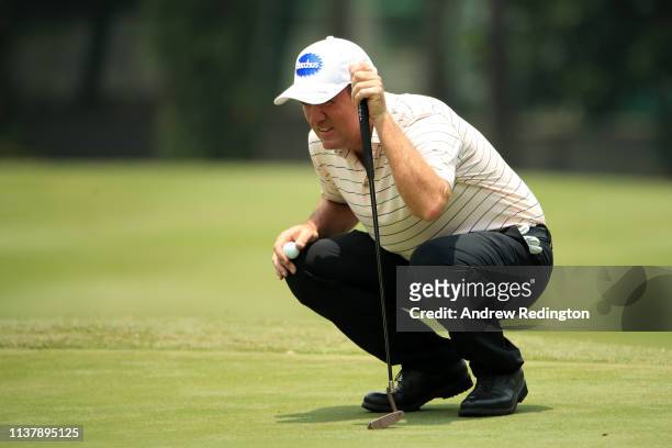 Scott Hend of Australia lines up a putt on the 11th green during Day Four of the Maybank Championship at Saujana Golf & Country Club, Palm Course on...