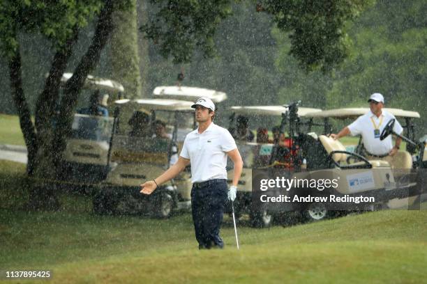 Nacho Elvira of Spain reacts after a thunder clap distracts him from playing his third shot on the 18th hole during Day Four of the Maybank...