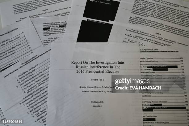 An illustration shows printed pages of the redacted Mueller Report at an office on April 18 in Washington, DC. - US Attorney General Bill Barr said...