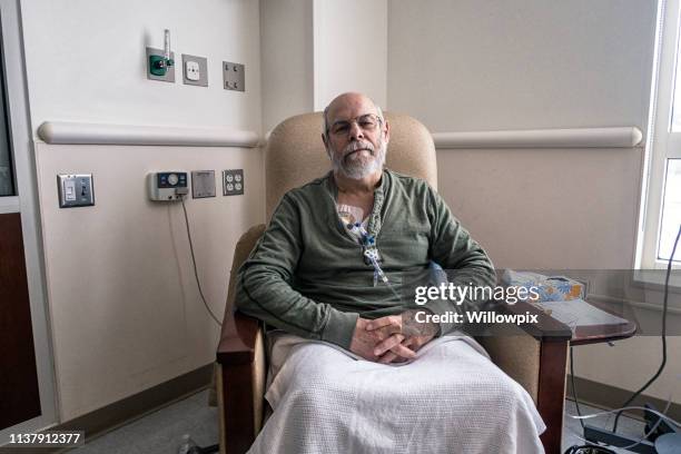 senior man clinic outpatient during cancer chemotherapy iv infusion - male chest stock pictures, royalty-free photos & images