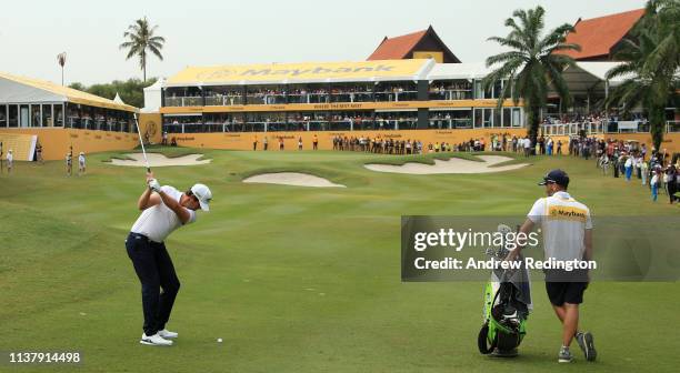 Scott Hend of Australia plays his shot on the first play off match against Nacho Elvira of Spain during Day Four of the Maybank Championship at...