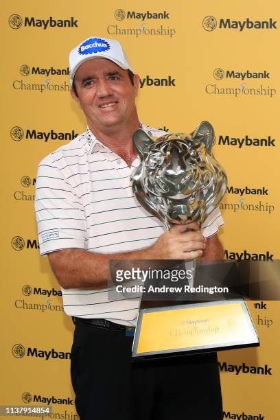 Scott Hend of Australia holds the trophy after he wins the play off match against Nacho Elvira of Spain during Day Four of the Maybank Championship...