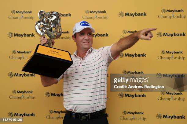 Scott Hend of Australia holds the trophy after he wins the play off match against Nacho Elvira of Spain during Day Four of the Maybank Championship...