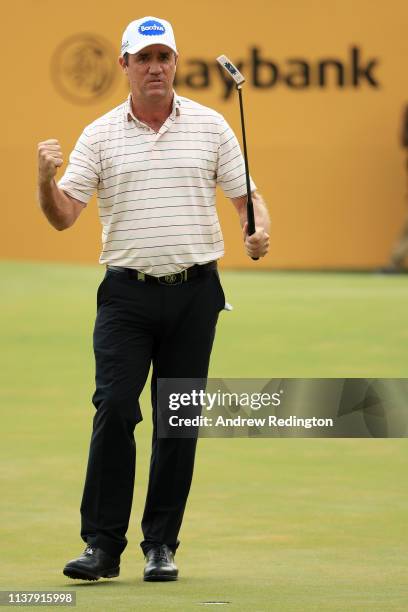 Scott Hend of Australia celebrates after his putt after he wins the play off match against Nacho Elvira of Spain during Day Four of the Maybank...
