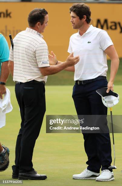 Scott Hend of Australia shakes hands he wins the play off match against Nacho Elvira of Spain during Day Four of the Maybank Championship at Saujana...