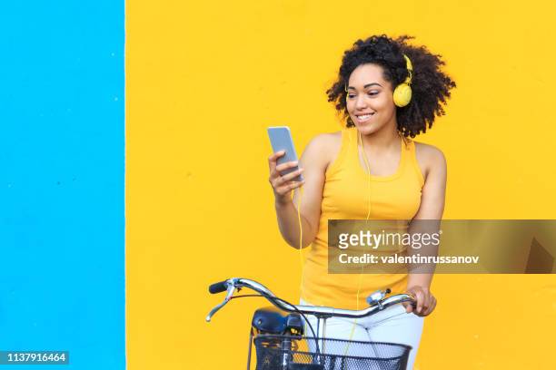 woman listening music in front of colored background - basket universitario imagens e fotografias de stock