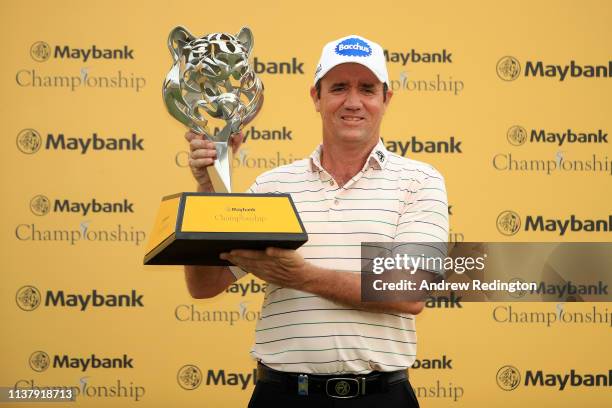 Scott Hend of Australia holds the trophy after he wins the play off match against Nacho Elvira of Spain during Day Four of the Maybank Championship...