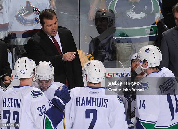 Head coach Alain Vigneault talks with Alex Burrows and Dan Hamhuis of the Vancouver Canucks during a timeout against the Nashville Predators in Game...