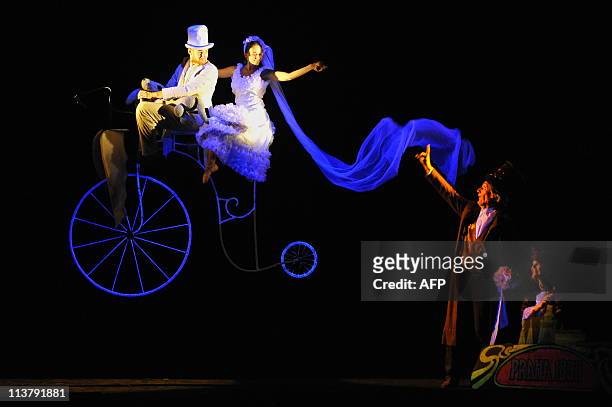 Actors of Prague's Black Theatre performs during a presentation of "The flying bike" at the Enrique Buenaventura Municipal theatre, in Cali,...