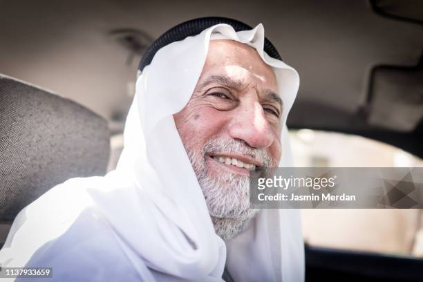 senior man in car - arab old man fotografías e imágenes de stock