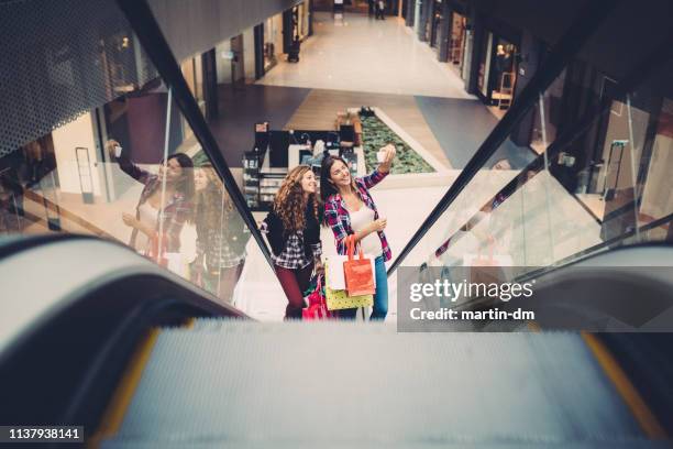 girls taking selfie in the shopping mall - shopping centre escalator stock pictures, royalty-free photos & images