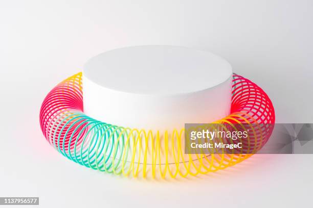 flexible coil surrounding cylinder - surrounding stock pictures, royalty-free photos & images