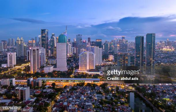 jakarta central business district blue hour from birdview - jakarta stock pictures, royalty-free photos & images