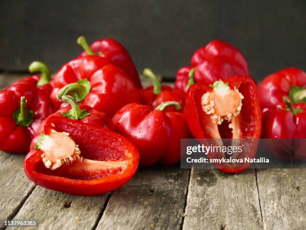 fresh sweet red pepper on old wooden background - pimiento dulce fotografías e imágenes de stock