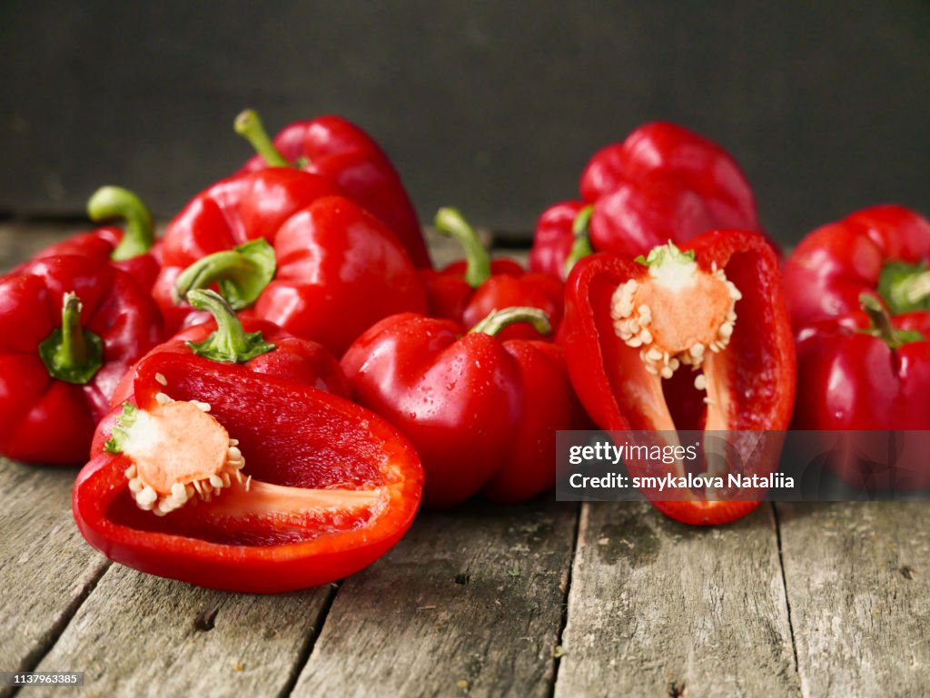 Fresh sweet red pepper on old wooden background