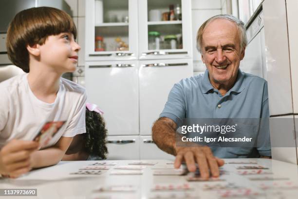 playing cards with grandson - remember stock pictures, royalty-free photos & images