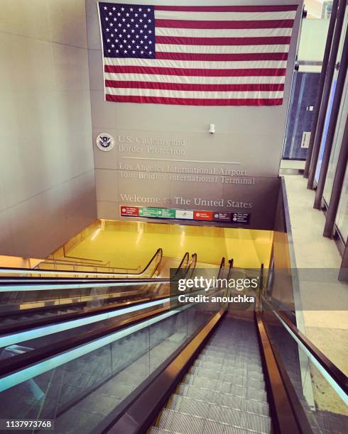us flag welcoming passengers arriving at lax airport, usa - lax airport stock pictures, royalty-free photos & images