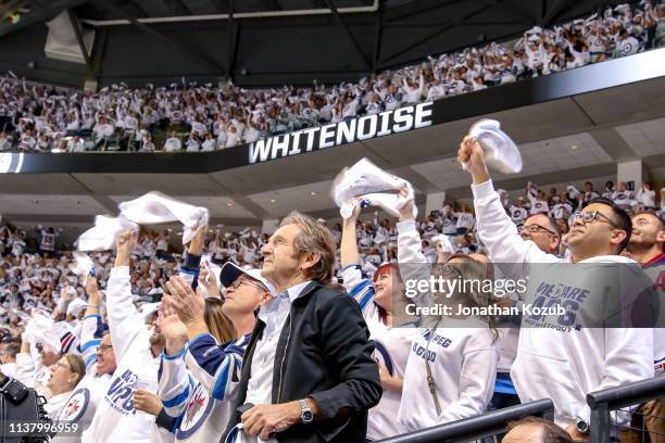 Fans stand and wave white towels as they cheer on the Winnipeg Jets during first period action against the St. Louis Blues in Game Five of the...