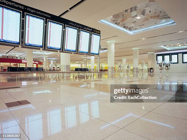 flight information displays at dubai airport - empty gate stock-fotos und bilder