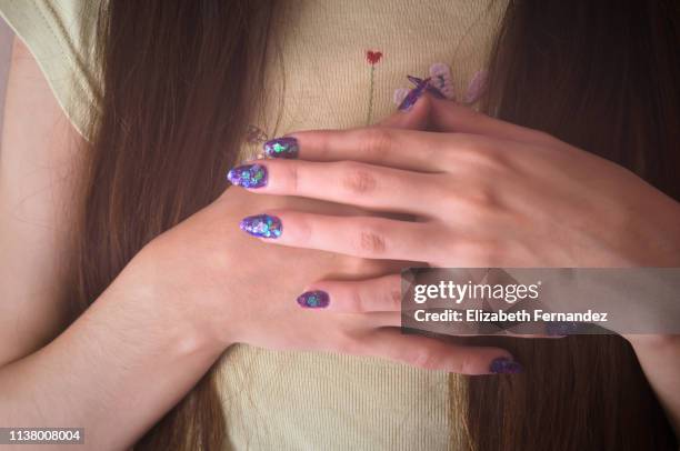 young woman with her hands on her chest - heart nail art stock pictures, royalty-free photos & images