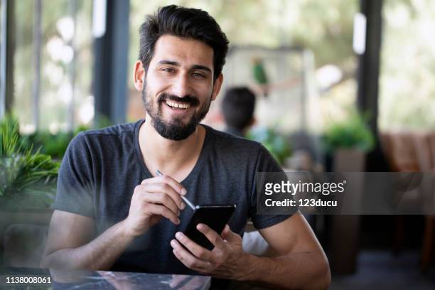 indian man at cafe - west asia stock pictures, royalty-free photos & images